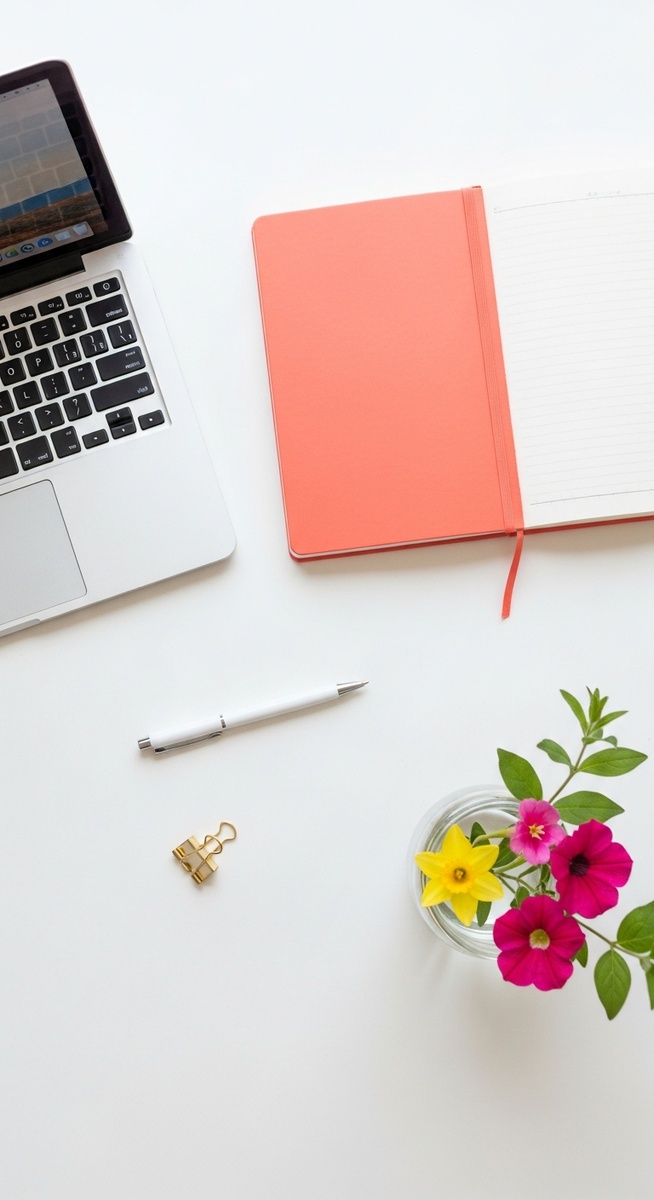flatlay with laptop and other items on a white surface