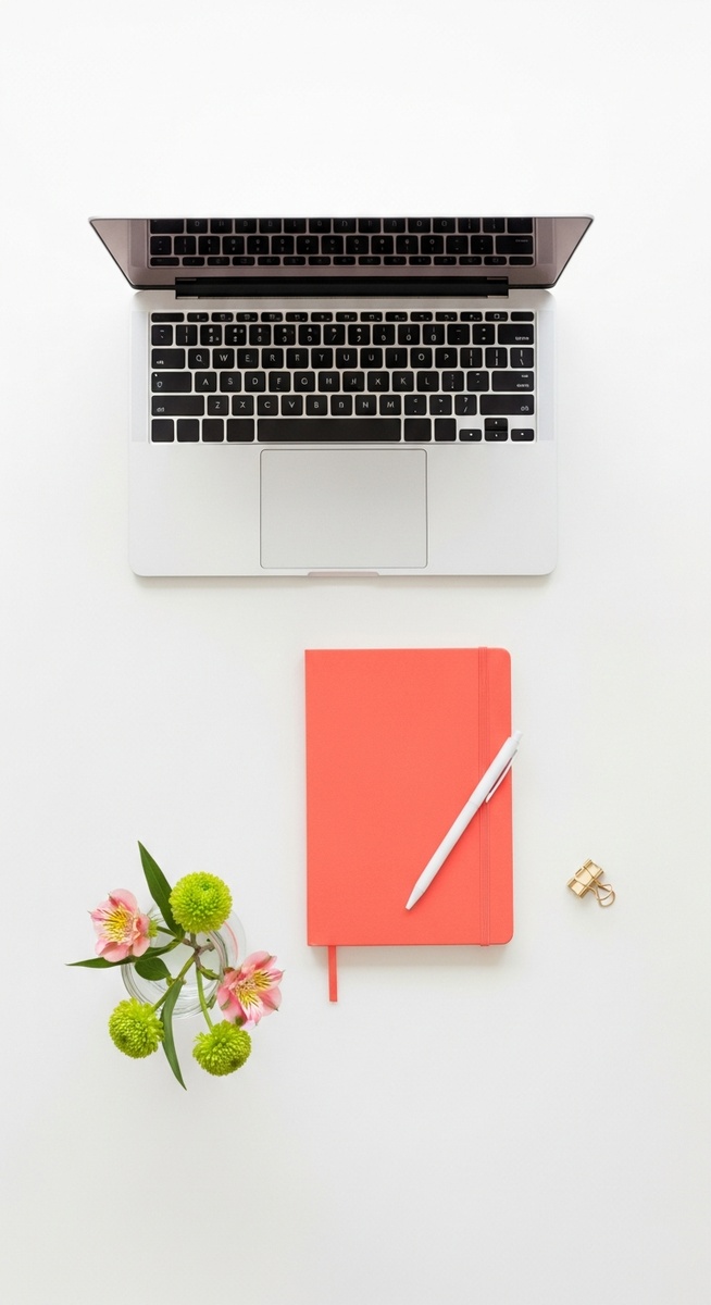 flatlay with laptop and other items on a white surface