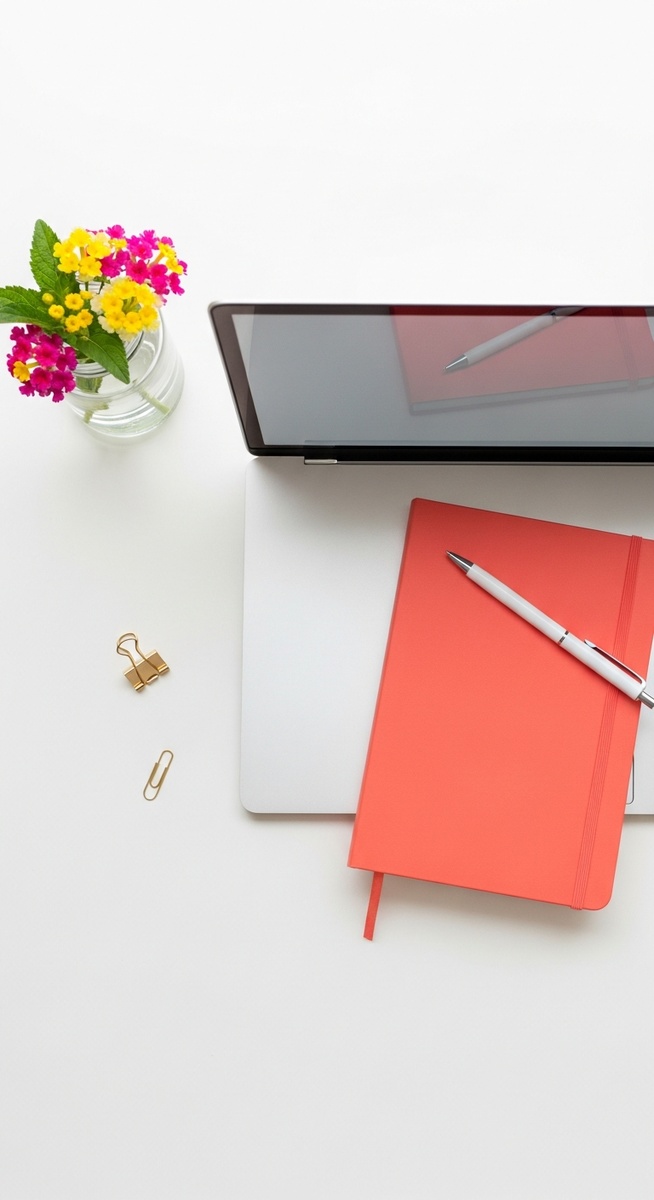 a flatlay with laptop and other items on a white surface for earning with surveys