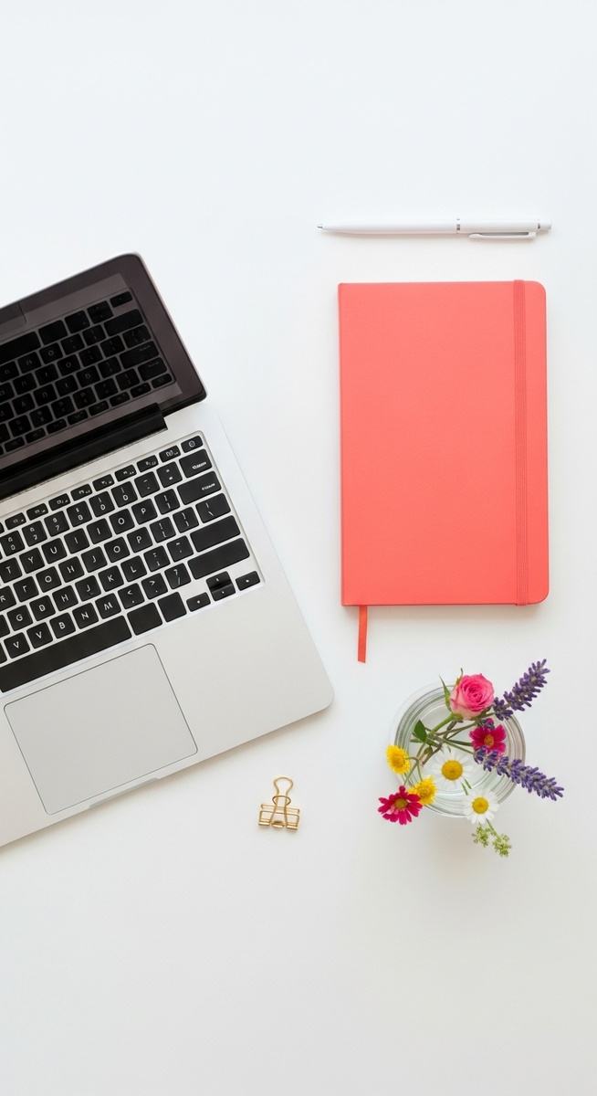 flatlay with laptop and other items on a white surface